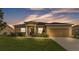Charming single-story home with a well-manicured lawn and a two-car garage during twilight at 1975 Country Manor St, Bartow, FL 33830