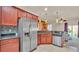 Open-concept kitchen with stainless steel appliances, granite counters, and an easy view to the backyard pool at 1975 Country Manor St, Bartow, FL 33830