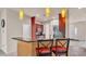 Open kitchen design with breakfast bar seating, sleek stainless steel appliances, and ample natural light at 1975 Country Manor St, Bartow, FL 33830