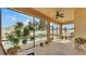Relaxing screened lanai showcasing a refreshing pool view, comfortable seating, and lush plants at 1975 Country Manor St, Bartow, FL 33830
