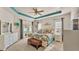 Bright main bedroom features a large bed, stylish decor, ceiling fan, and sliding glass doors to the outside at 1975 Country Manor St, Bartow, FL 33830