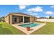Inviting in-ground pool surrounded by lush green grass and a screened-in patio makes outdoor living a breeze at 1975 Country Manor St, Bartow, FL 33830