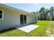 Back patio with sliding glass door overlooking private yard; ideal for outdoor living at 200 Locust Pass, Ocala, FL 34472