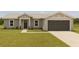 Charming single-story home featuring a well-manicured lawn, an attached garage, and a welcoming entrance at 200 Locust Pass, Ocala, FL 34472