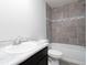 Bathroom featuring a tiled shower and tub combination, marble countertops, and modern fixtures at 2234 Oldham Ct, Haines City, FL 33844