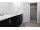 Bathroom with double vanity, marble countertop, modern faucets, and view to walk-in closet at 2234 Oldham Ct, Haines City, FL 33844