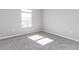 Cozy bedroom featuring gray carpet, neutral paint, and a sunlit window at 2234 Oldham Ct, Haines City, FL 33844