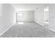 Large bedroom featuring gray carpet, neutral walls, bright window, and hallway access at 2234 Oldham Ct, Haines City, FL 33844
