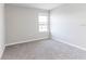 A neutral bedroom featuring a window, carpeted flooring, and electrical outlets at 2234 Oldham Ct, Haines City, FL 33844