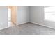 Bright bedroom with gray carpet and neutral walls features natural light from a window at 2234 Oldham Ct, Haines City, FL 33844