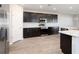 Modern kitchen with stainless steel appliances, dark cabinets, and light countertops at 2234 Oldham Ct, Haines City, FL 33844