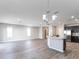Spacious living area with ample lighting, wood-look flooring, and stainless steel appliances at 2234 Oldham Ct, Haines City, FL 33844