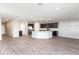A wide-open living area with wood-look flooring, stainless steel appliances, and neutral paint at 2234 Oldham Ct, Haines City, FL 33844