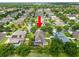 Aerial view of a beautiful home in a neighborhood, featuring a screen-enclosed pool at 228 Magneta Loop, Auburndale, FL 33823