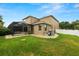 This is a view of the back of a house and yard, featuring the pool screen at 228 Magneta Loop, Auburndale, FL 33823