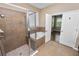 Bathroom features glass shower, soaking tub, and neutral tile; a serene retreat at 228 Magneta Loop, Auburndale, FL 33823