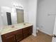 Bathroom with double sink vanity, and large mirror, offering ample space and functionality at 228 Magneta Loop, Auburndale, FL 33823