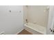 Bright bathroom featuring a tiled shower with a bathtub, offering a clean and modern look at 228 Magneta Loop, Auburndale, FL 33823