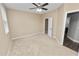 Neutral bedroom with a ceiling fan, closet and an open doorway offering a clean, cozy space at 228 Magneta Loop, Auburndale, FL 33823