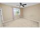 Bedroom with a large window, filled with natural light and a ceiling fan at 228 Magneta Loop, Auburndale, FL 33823