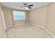Bright, carpeted bedroom with a large window, light pink curtains and a ceiling fan at 228 Magneta Loop, Auburndale, FL 33823