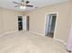 Neutral bedroom with plush carpeting and open doors to an additional bedroom, a walk-in closet, and a bathroom at 228 Magneta Loop, Auburndale, FL 33823
