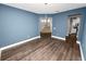 Dining room with blue walls, hardwood floors, and a view of the staircase and kitchen at 228 Magneta Loop, Auburndale, FL 33823