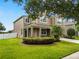 Charming two-story home featuring a landscaped yard, covered porch, and a well-maintained lawn at 228 Magneta Loop, Auburndale, FL 33823