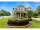Charming two-story home featuring a landscaped yard, covered porch, and a well-maintained lawn at 228 Magneta Loop, Auburndale, FL 33823