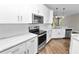 Stylish kitchen equipped with stainless appliances, marble counters, and ample storage at 228 Magneta Loop, Auburndale, FL 33823
