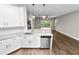 Bright kitchen featuring modern appliances, countertop seating, and a view to the pool area at 228 Magneta Loop, Auburndale, FL 33823