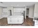 Spacious kitchen boasts a center island, stainless appliances, and abundant white cabinetry at 228 Magneta Loop, Auburndale, FL 33823