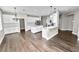 Modern kitchen featuring white cabinetry, granite countertops, stainless steel appliances, and an open layout at 228 Magneta Loop, Auburndale, FL 33823