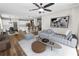 Stylish living room with hardwood floors, modern furnishings, and an open layout connecting to the dining and kitchen areas at 228 Magneta Loop, Auburndale, FL 33823