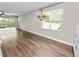 Open-concept living and dining area with contemporary light fixture and sliding glass doors to outdoor patio at 228 Magneta Loop, Auburndale, FL 33823