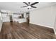 Open-concept living space with elegant hardwood flooring leading into a bright and modern kitchen area at 228 Magneta Loop, Auburndale, FL 33823