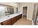 Main bathroom with dual sinks, a large mirror, a walk-in shower, and a soaking tub at 228 Magneta Loop, Auburndale, FL 33823