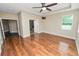 Main bedroom with hardwood floors, a ceiling fan, natural light, and an ensuite bathroom at 228 Magneta Loop, Auburndale, FL 33823