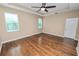 Main bedroom featuring hardwood flooring, a ceiling fan, and plenty of natural light from multiple windows at 228 Magneta Loop, Auburndale, FL 33823