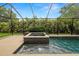 Inviting pool and spa surrounded by lush tropical foliage, providing a private oasis at 228 Magneta Loop, Auburndale, FL 33823