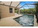 This is a view of a patio and screened-in pool at 228 Magneta Loop, Auburndale, FL 33823