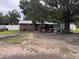 Single story home with a large tree in the front yard and a trailer nearby at 2293 Pump Rd, Mulberry, FL 33860