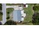 An aerial view of the house, featuring a patio seating area and a spacious yard at 2333 Cheshire Pl, Lakeland, FL 33810