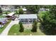 Aerial view of a two-story home with a well-kept lawn, driveway, and surrounding neighborhood at 2333 Cheshire Pl, Lakeland, FL 33810