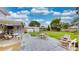 Charming backyard featuring an outdoor bar, shed, lush green lawn, and seating area, perfect for entertaining at 2333 Cheshire Pl, Lakeland, FL 33810