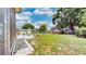 Large backyard with a patio seating area, a well-maintained lawn and chain link fence at 2333 Cheshire Pl, Lakeland, FL 33810