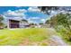 A view of the fenced-in backyard with a shed, patio furniture, and a well-maintained lawn at 2333 Cheshire Pl, Lakeland, FL 33810