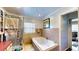 This bathroom offers a jacuzzi tub, walk in shower, and tiled walls for easy maintenance at 2333 Cheshire Pl, Lakeland, FL 33810