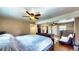 Large bedroom featuring hardwood floors, ceiling fans, and access to the outdoors at 2333 Cheshire Pl, Lakeland, FL 33810