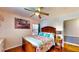 Comfortable bedroom featuring wood floors, bright windows, and a ceiling fan at 2333 Cheshire Pl, Lakeland, FL 33810